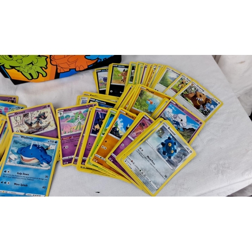 139 - Large assortment of Pokémon trading cards, featuring collectible tins and boxes for organization. In... 