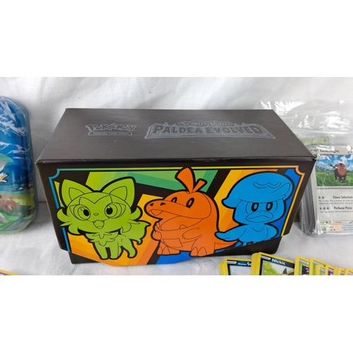 139 - Large assortment of Pokémon trading cards, featuring collectible tins and boxes for organization. In... 