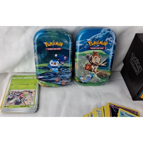 139 - Large assortment of Pokémon trading cards, featuring collectible tins and boxes for organization. In... 