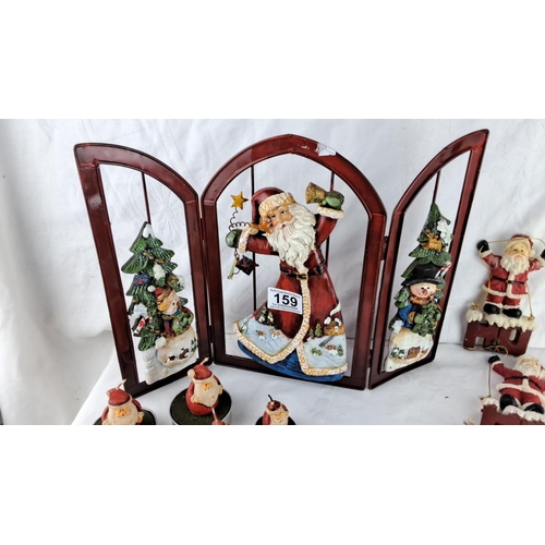 159 - Decorative lot  of Christmas themed items to includes a tri-fold panel, ceramic figures, and seven S... 