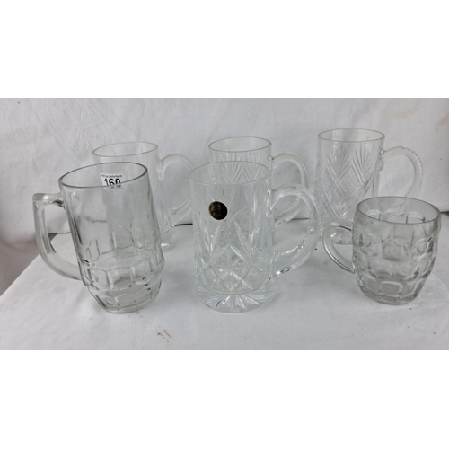 160 - Collection of glass beer mugs with various cut patterns, including diamond and geometric designs.