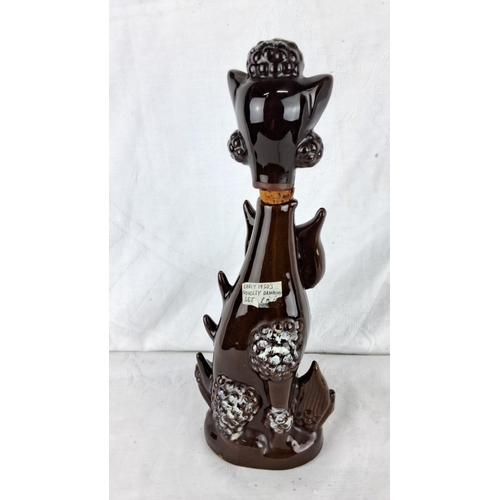 174 - Ceramic whiskey decanter, 1950s, featuring a whimsical dog design with a removable head stopper. Vib... 