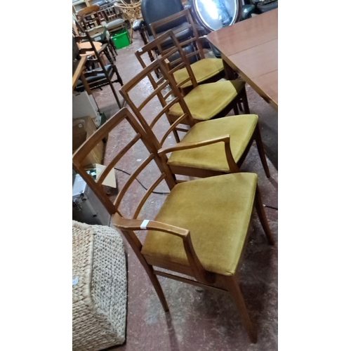 527 - Mid-Century Modern dining table and four chairs set, featuring a sleek teak design with ladder-back ... 