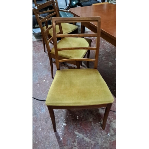 527 - Mid-Century Modern dining table and four chairs set, featuring a sleek teak design with ladder-back ... 