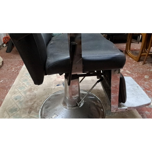 532 - Vintage black leather barber chair with chrome base and adjustable headrest.