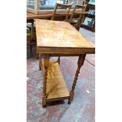 533 - Vintage oak console table with intricate parquet design and turned legs. Includes a lower shelf.