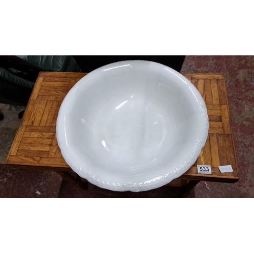 541 - White porcelain wash basin with intricate rim detailing.