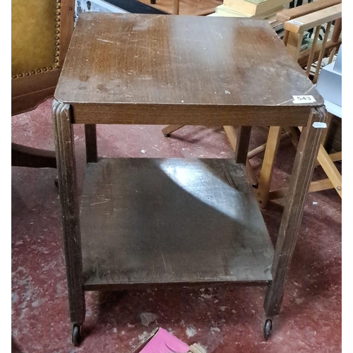 543 - Vintage oak side table with caster wheels, featuring a square top and lower shelf.