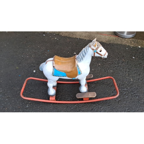 557 - Vintage Tri-ang rocking horse, painted metal with brown saddle and blue detailing, on a sturdy red m... 