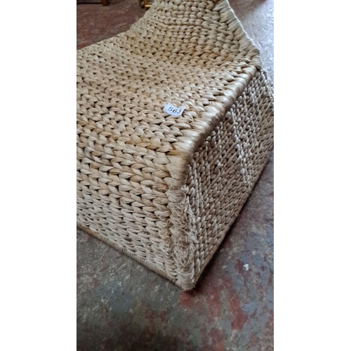 563 - Handwoven seagrass sled-shaped rocking chair, featuring intricate braided design.