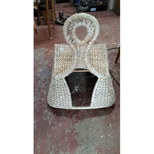 563 - Handwoven seagrass sled-shaped rocking chair, featuring intricate braided design.