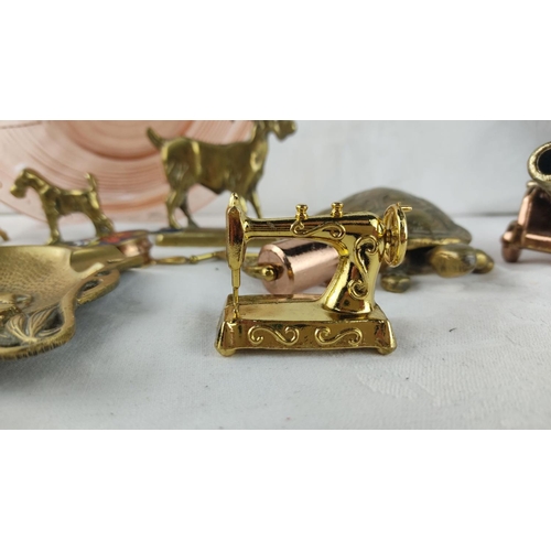 409 - Assorted vintage brass miniatures including a sewing machine, animals, and decorative objects. Inclu... 