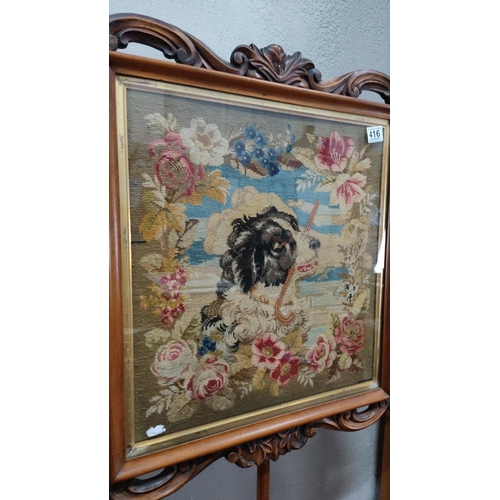 416 - Victorian walnut pole screen with a floral and dog motif tapestry panel. The frame features intricat... 