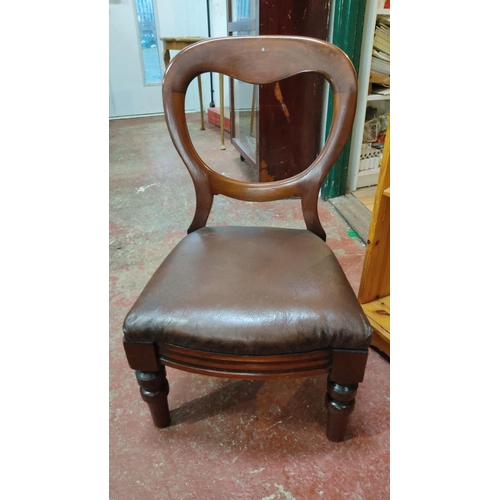 421 - Victorian mahogany balloon-back nursing chair with brown upholstered seat, featuring turned legs and... 