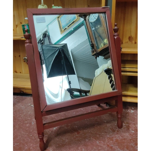 422 - Cheval mirror with red-painted wooden frame and stand, featuring turned finials.