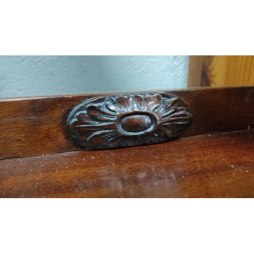 423 - Mahogany demi-lune side table with carved details and elegantly turned legs, featuring a central ped... 