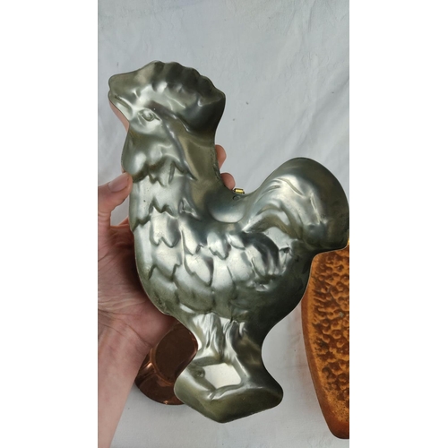 429 - Copper and brass decorative lot including rooster mold, pitchers, and tray. Rich patina highlights v... 