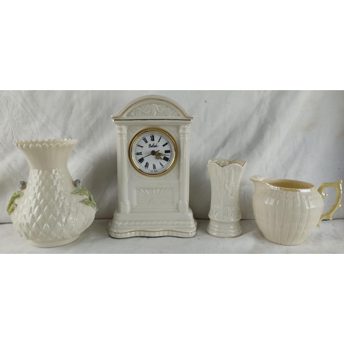 432 - Belleek porcelain collection features a clock, vase, pitcher, and small decorative jug with floral d... 