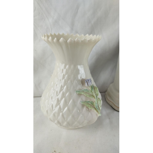 432 - Belleek porcelain collection features a clock, vase, pitcher, and small decorative jug with floral d... 