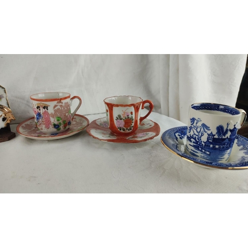 436 - Assorted porcelain teacup set with floral and traditional motifs, includes saucers. Features various... 