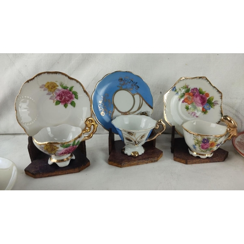 436 - Assorted porcelain teacup set with floral and traditional motifs, includes saucers. Features various... 