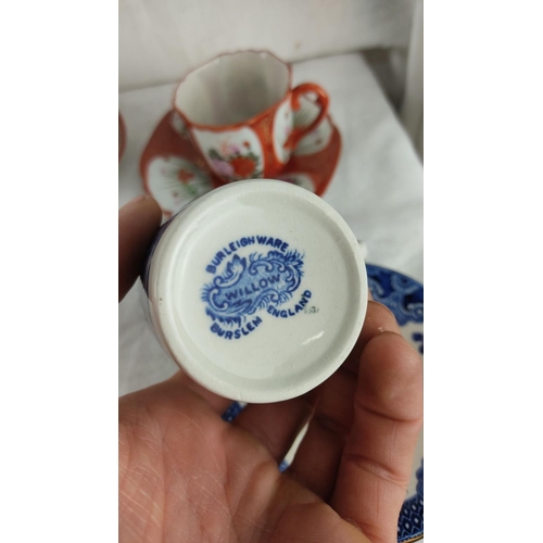 436 - Assorted porcelain teacup set with floral and traditional motifs, includes saucers. Features various... 