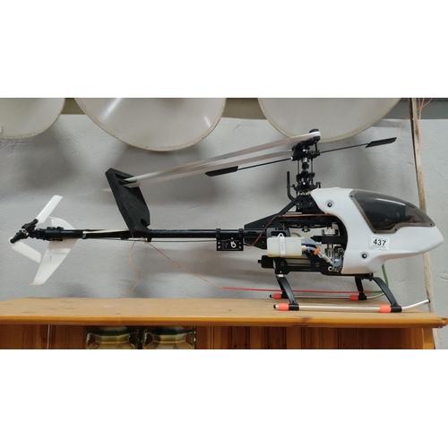 437 - Remote control helicopter with aerodynamic design. Features a fuel tank and servo mechanisms. Model ... 