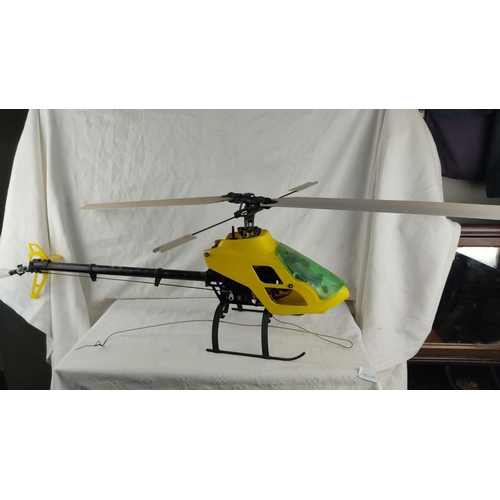 438 - Large remote-controlled helicopter with yellow and green canopy. Durable black landing skids. (helic... 