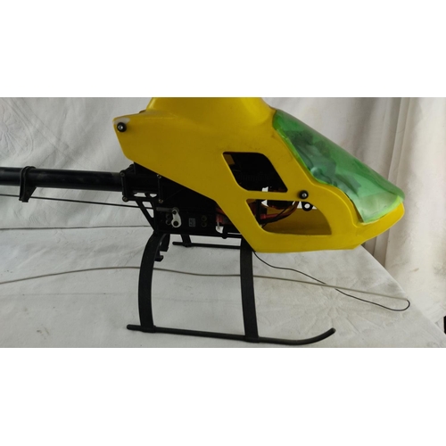 438 - Large remote-controlled helicopter with yellow and green canopy. Durable black landing skids. (helic... 