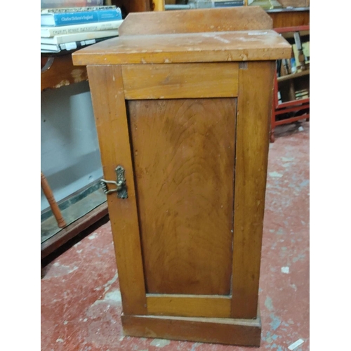 446 - Vintage wooden cabinet with a single hinged door and metal latch, featuring a flat top surface. From... 