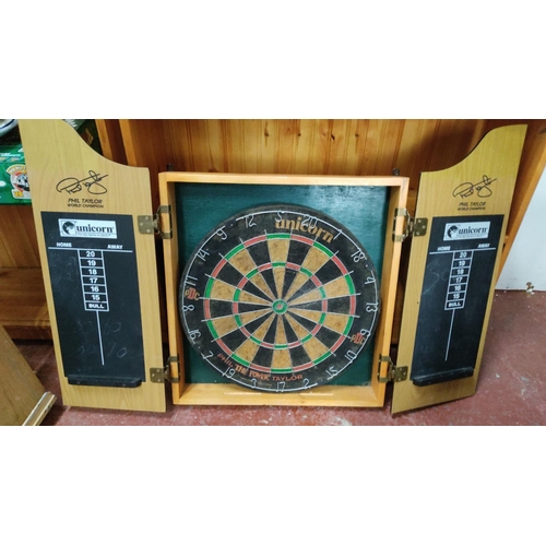 456 - Unicorn dartboard set with cabinet, featuring scoring panels and a bristle dartboard.