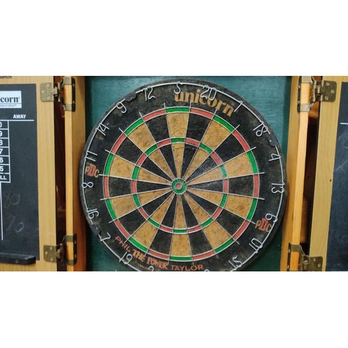 456 - Unicorn dartboard set with cabinet, featuring scoring panels and a bristle dartboard.