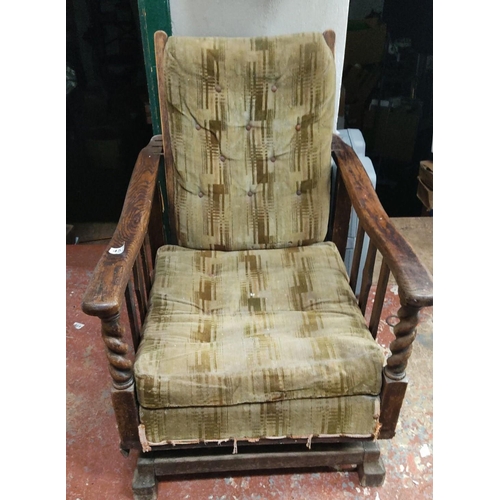 457 - Vintage wooden armchair with patterned upholstery, featuring twisted spindle armrests and a rustic f... 