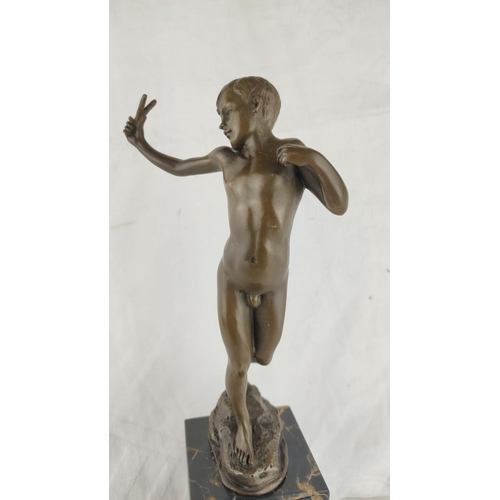 461 - Stunning Bronze sculpture of a boy, poised on a black marble base.