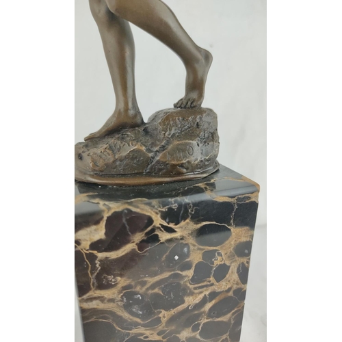 461 - Stunning Bronze sculpture of a boy, poised on a black marble base.