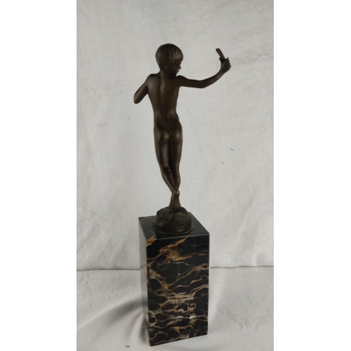 461 - Stunning Bronze sculpture of a boy, poised on a black marble base.