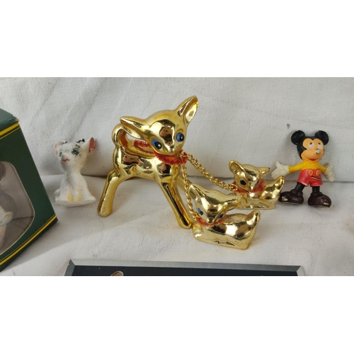 477 - Collection includes a gold-tone deer figurine with fawns, Mickey Mouse figurine, assorted cork stopp... 