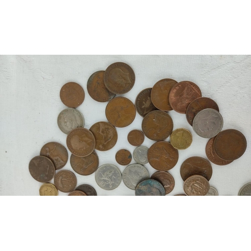 485 - Mixed lot of assorted coins, featuring various historical and international designs, highlighting di... 