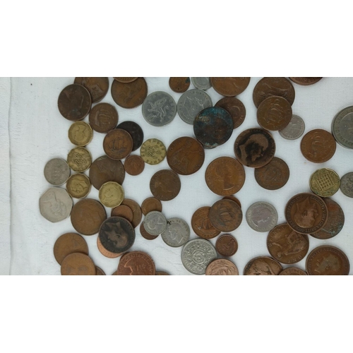 485 - Mixed lot of assorted coins, featuring various historical and international designs, highlighting di... 