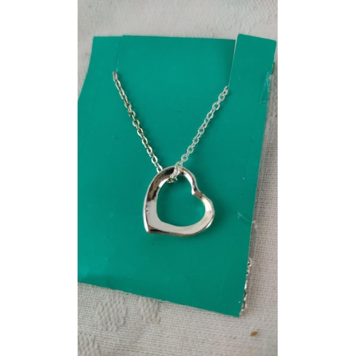 495 - Sterling silver heart necklace with delicate chain, contemporary design.