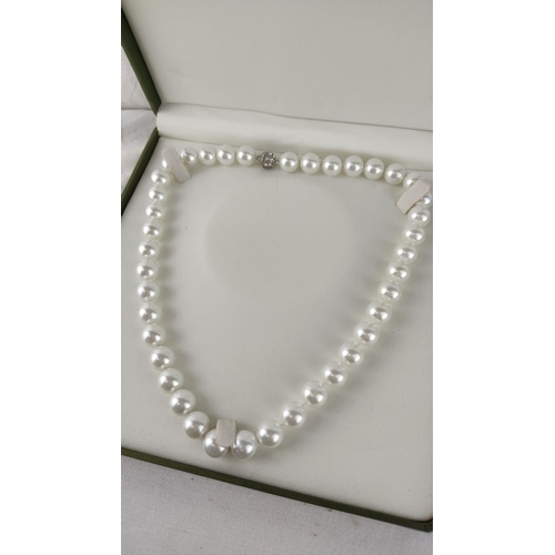 498 - Classic pearl necklace in box, featuring lustrous white pearls and an ornate sterling silver clasp.