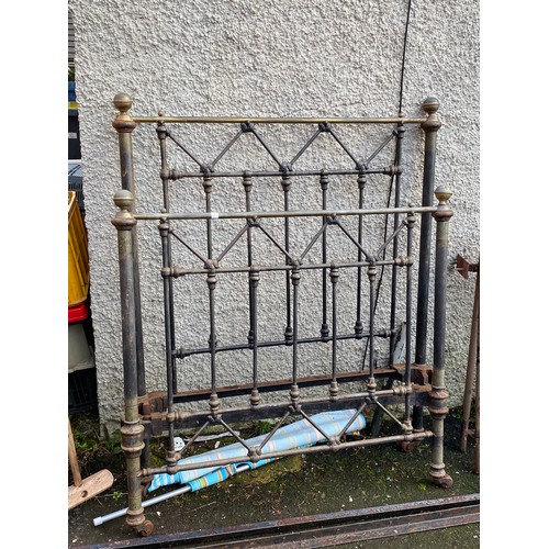 464 - An antique cast iron bed frame with hand painted details. 108x130cm