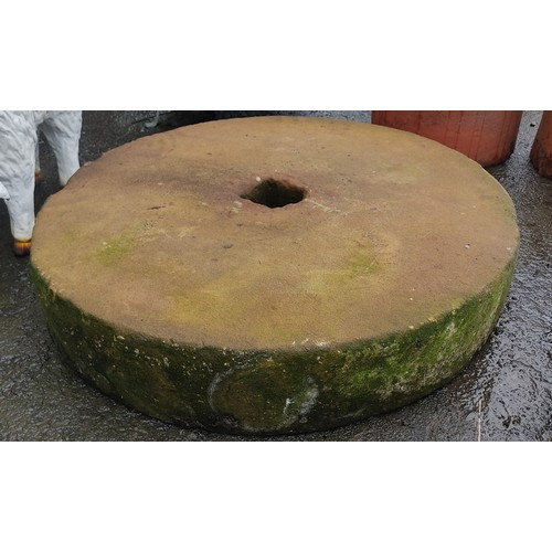 169 - An antique mill stone, measuring 64cm x 12cm.