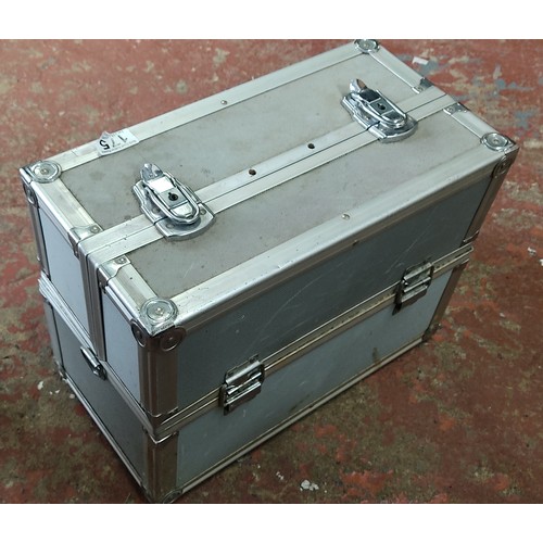 175 - Metal storage case with dual locks and foam interior, containing assorted tools and accessories.