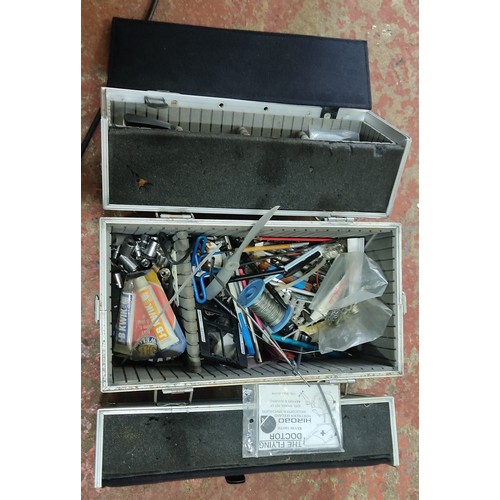 175 - Metal storage case with dual locks and foam interior, containing assorted tools and accessories.