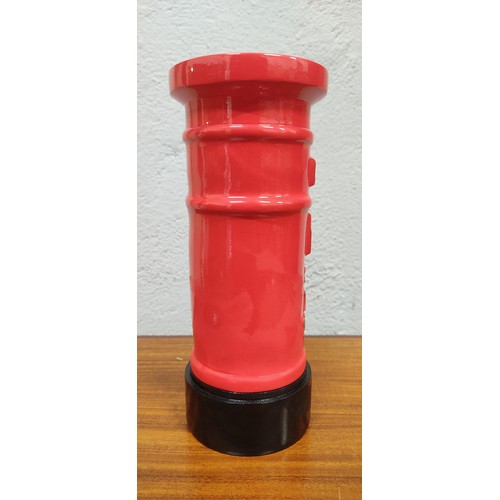 311 - A novelty Royal Mail metal money box. Measuring approx 20cm tall