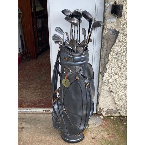 230 - A set of golf clubs.