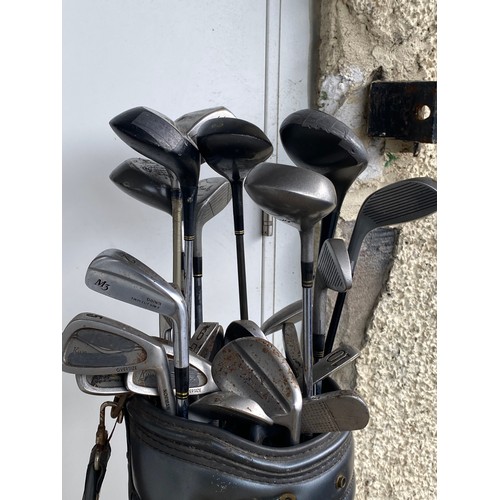 230 - A set of golf clubs.