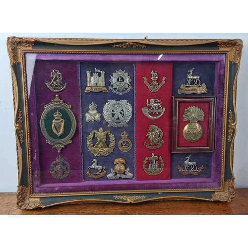 58 - A stunning framed display of Military cap badges.