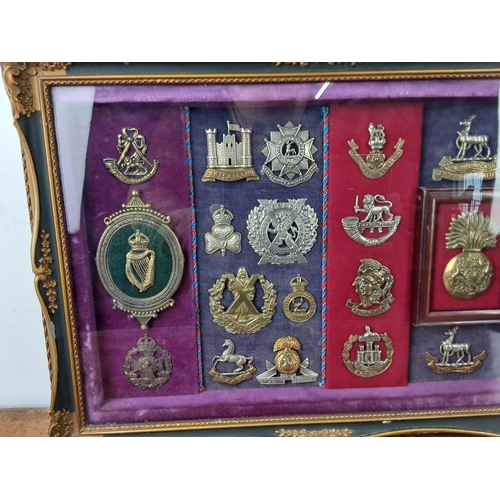 58 - A stunning framed display of Military cap badges.